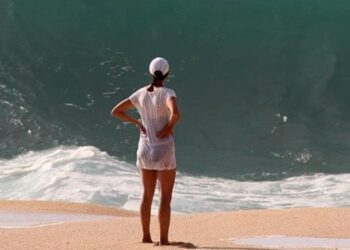 Popular meme of woman standing in front of huge wave (Imgur)