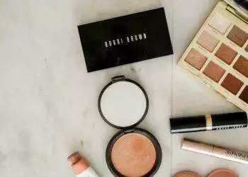 Makeup products laid out on table (Unsplash | element5digital)