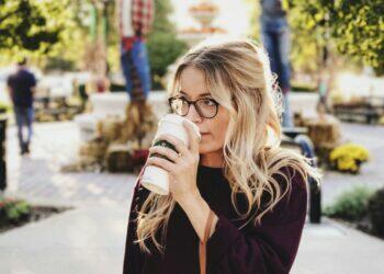 Woman drinking coffee outdoors (Unsplash | Caleb George)