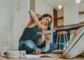 Woman sitting on the floor installing a DIY project (Unsplash | oppofindx5pro)