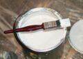 White paint and paintbrush (Unsplash | henry perks)