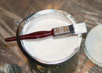 White paint and paintbrush (Unsplash | henry perks)