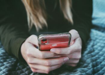 Woman on phone (Unsplash | Tim Mossholder)