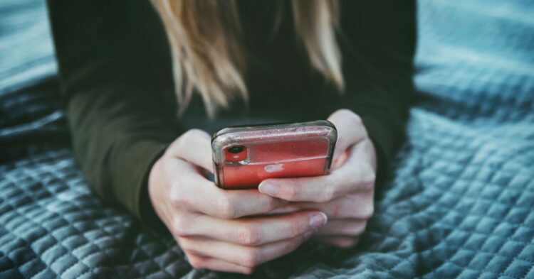 Woman on phone (Unsplash | Tim Mossholder)