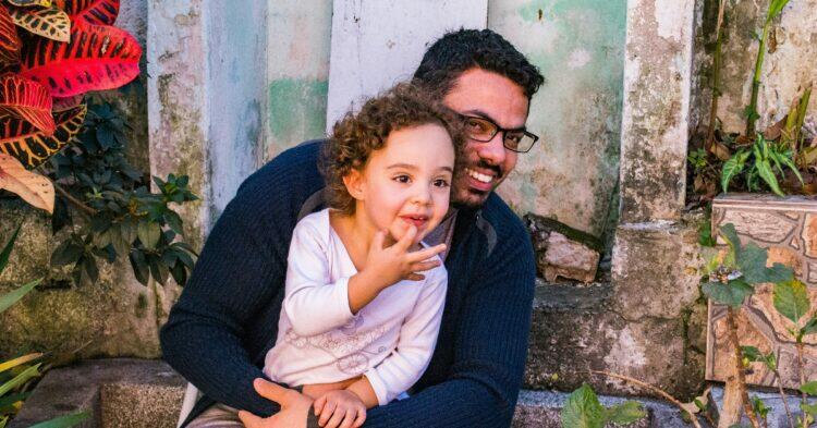 Father and daughter sitting at doorstep (Unsplash | Jonas Kakaroto)