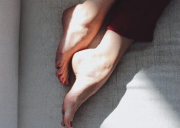 Image of feet on bed (Unsplash | Misha Gord)