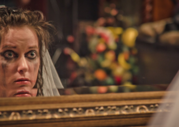 Bride with smudged makeup stares at herself in the mirror (Getty Images | meshaphoto)