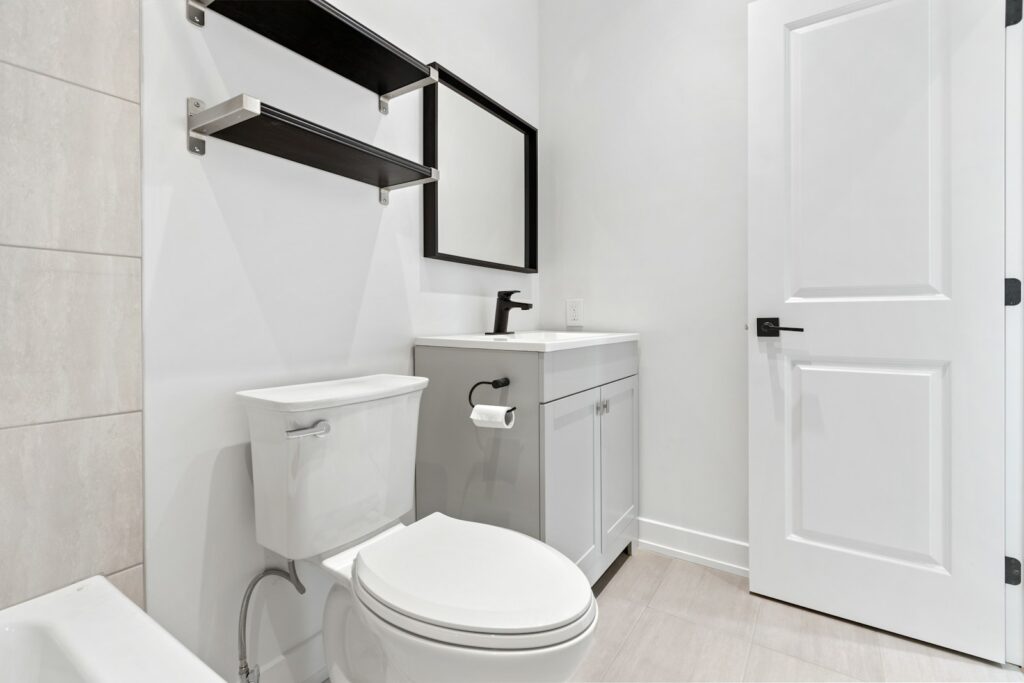 a white bathroom with a toilet and sink