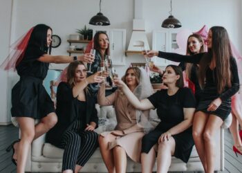 group of women sitting on white floor