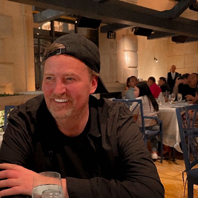 Matthew Perry smiling in a restaurant