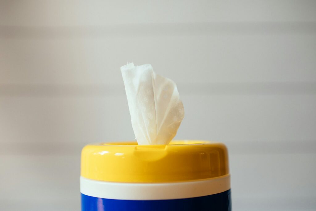yellow blue and white plastic container in front of a white wall
