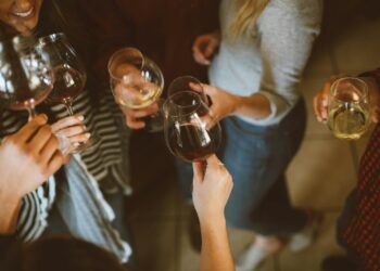 group of people tossing wine glass