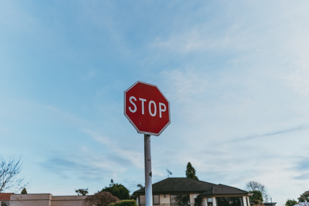 An image of a stop sign against a blue sky.