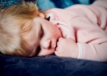baby sleeping on black surface