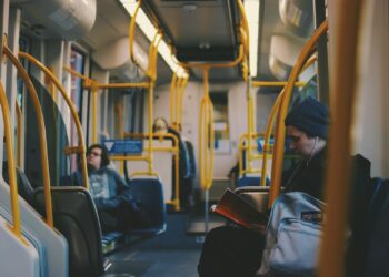 A man sitting inside a mostly empty bus