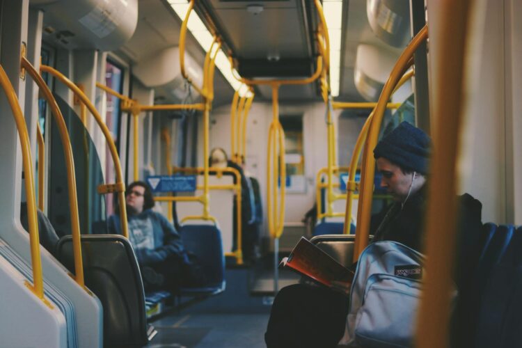 A man sitting inside a mostly empty bus