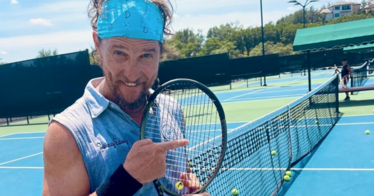 matthew mcconaughey on a tennis court holding a tennis racket