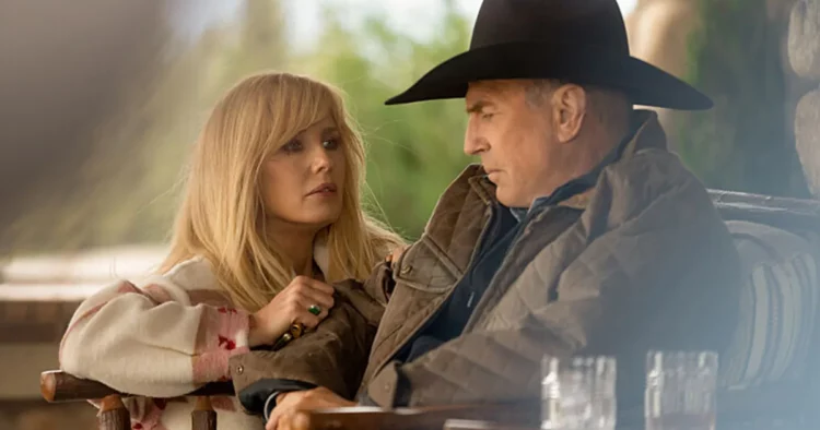 a still from “yellowstone” of a woman kneeling next to a man
