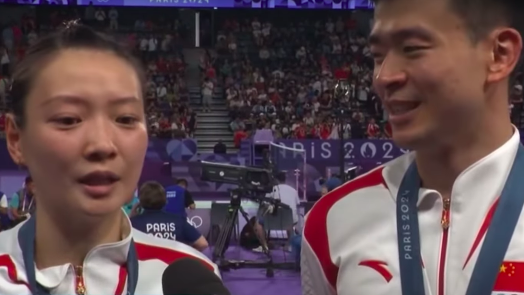 Huang Ya Qiong and Zheng Siwei being interviewed in a stadium