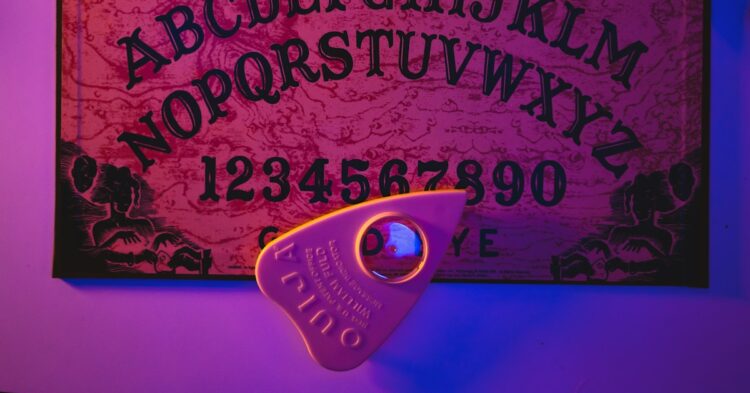 a purple lit room with a sign and a pair of scissors
