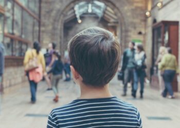 boy standing inside closed room