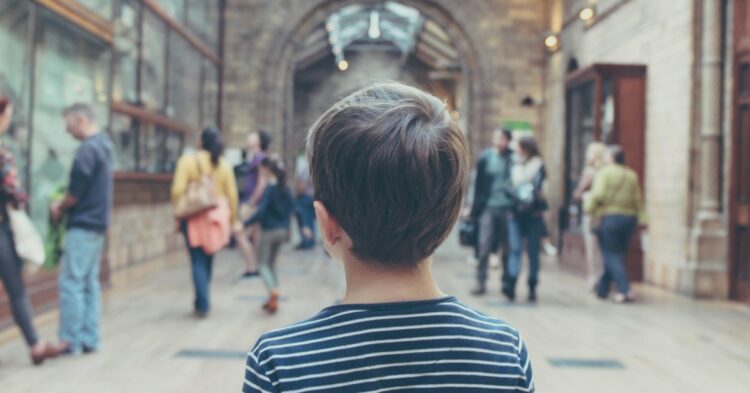 boy standing inside closed room