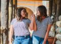 two smiling women while holding their hands at daytime