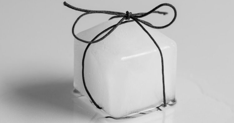 a white square box tied with a black string