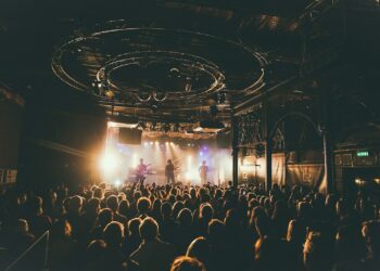 people attending concert inside dark room