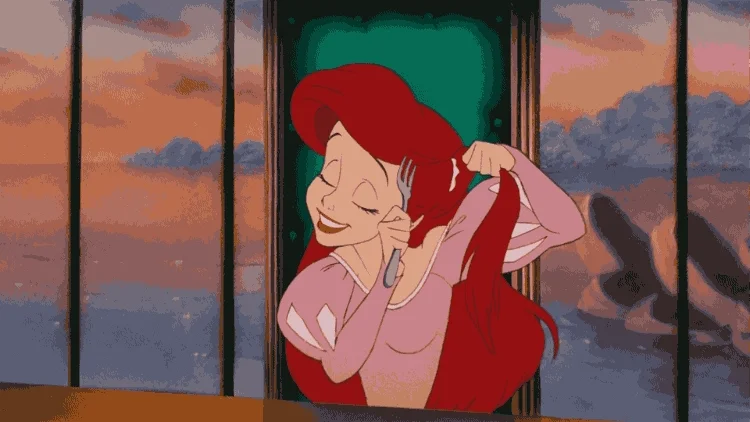 Ariel from the Little Mermaid in a pink dress using a fork to brush her hair