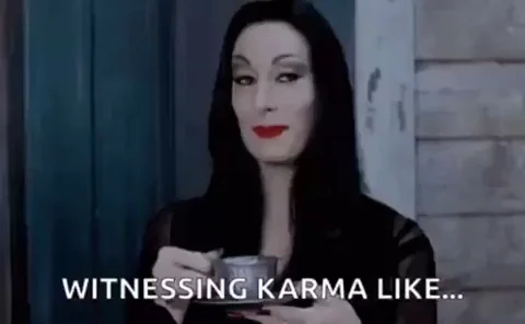 A gif of Morticia Addams sipping tea with the words