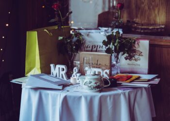two red roses and mr. & mrs. free-standing letters on top of table