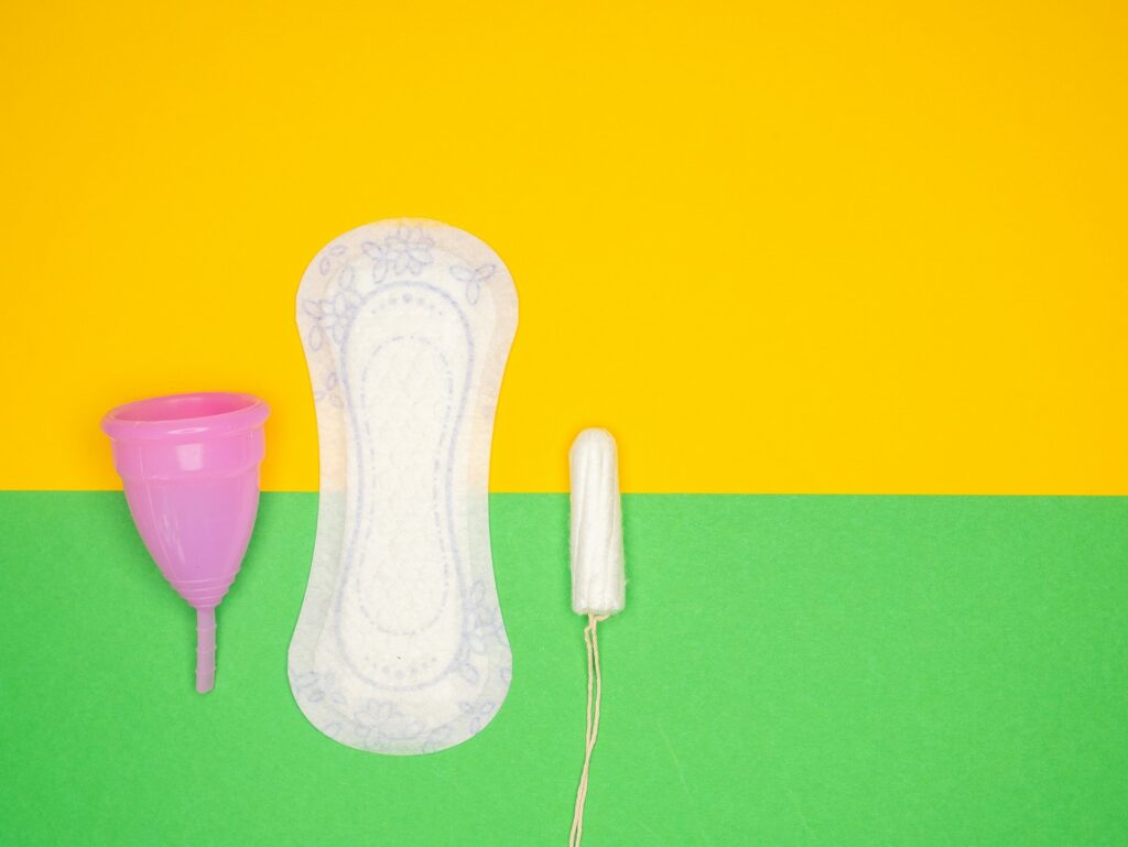 a hairdryer and a pair of shoes on a green and yellow background