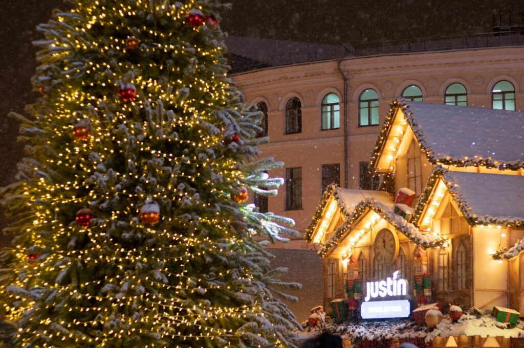 a large christmas tree in front of a building