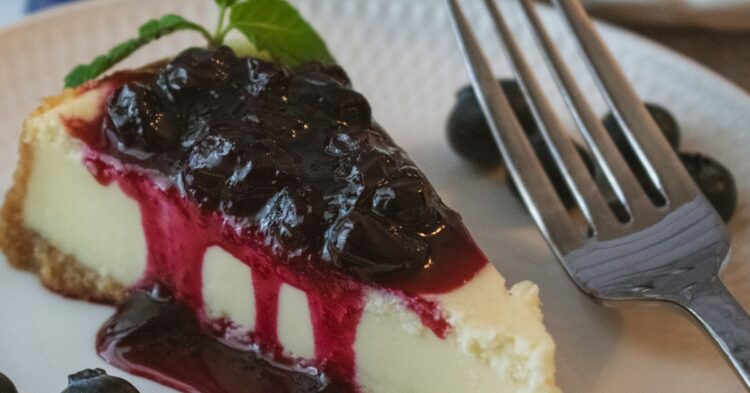 a piece of cheesecake with blueberries on a plate
