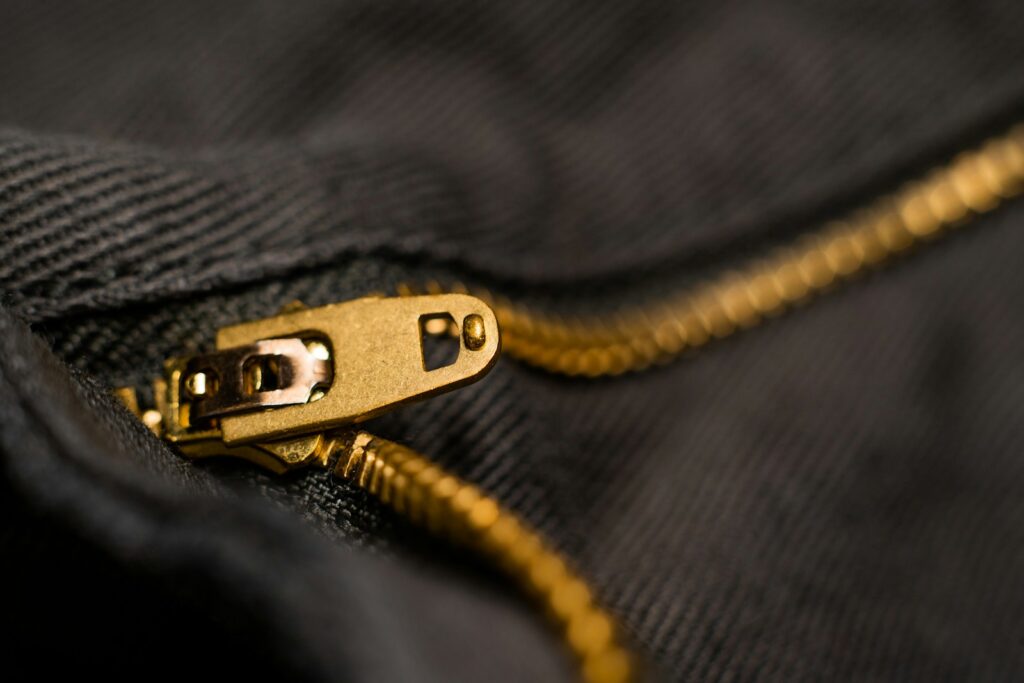 gold zipper on a black pair of pants