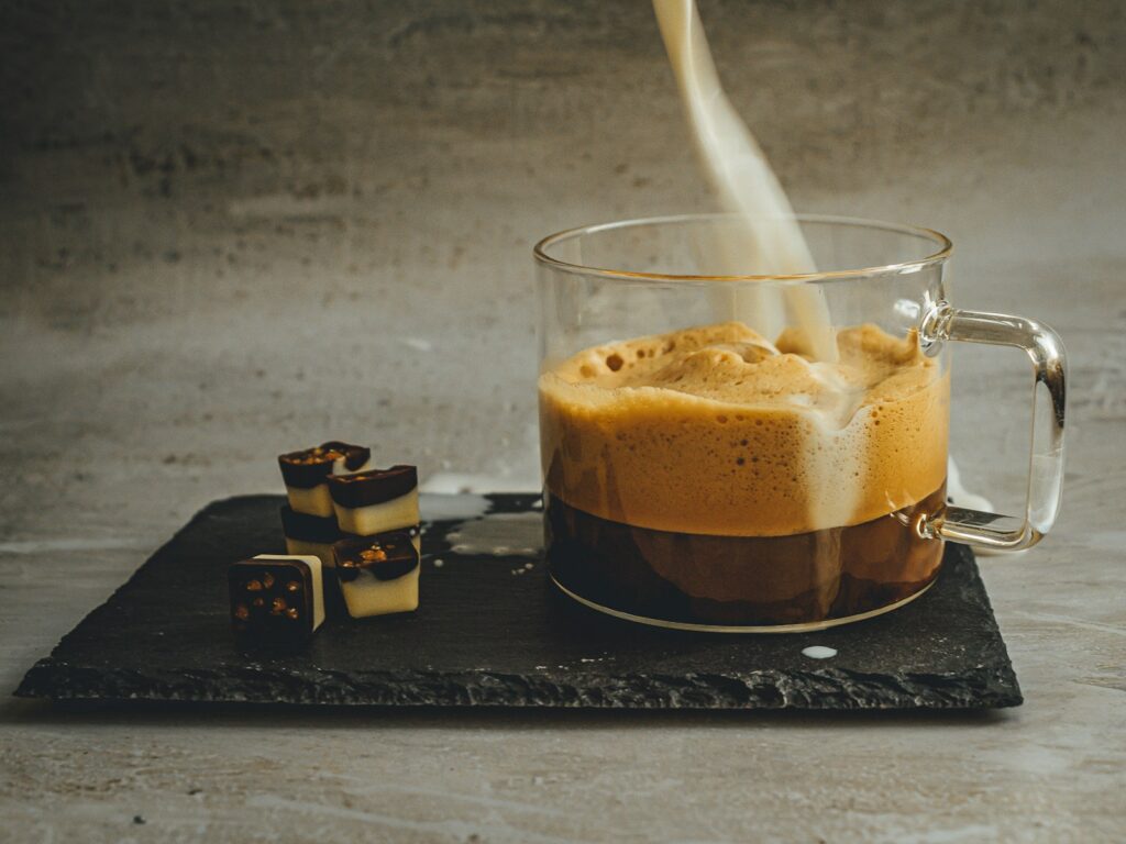 clear drinking glass with brown liquid