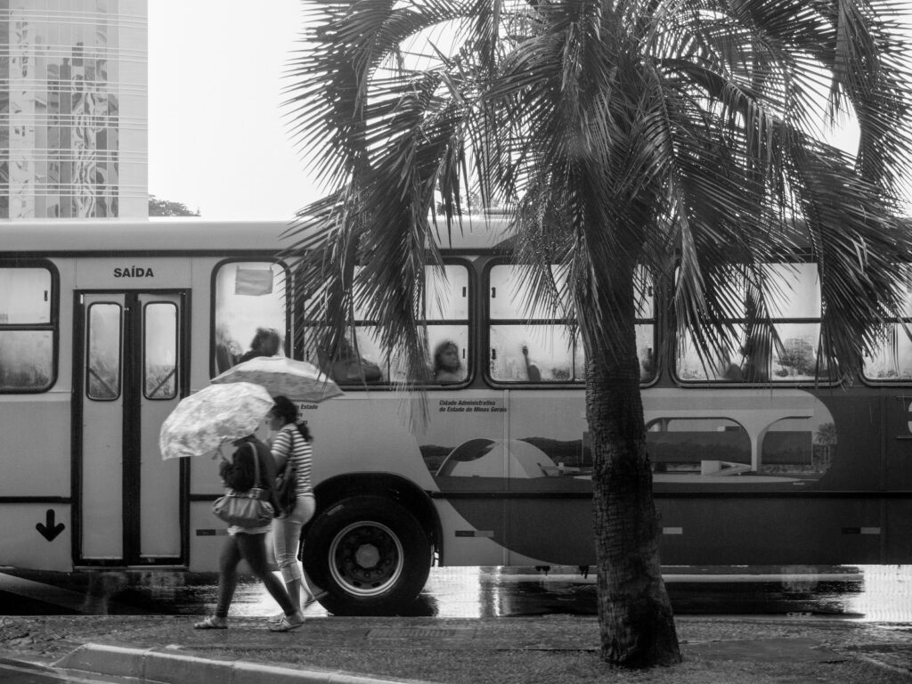 a black and white photo of a person with an umbrella