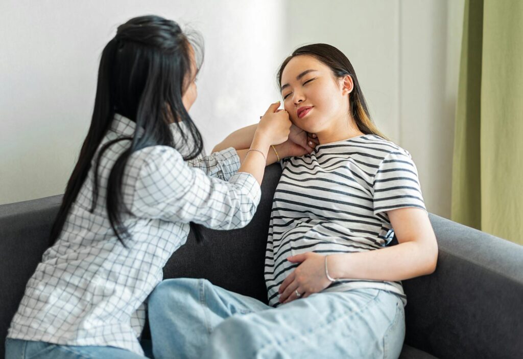 Pregnant with her Friend on Sofa