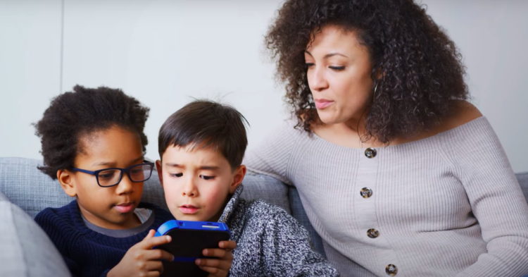 Mother supervises children playing video game via YouTube
