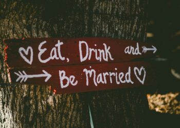 Eat Drink and Be Married sign on a tree