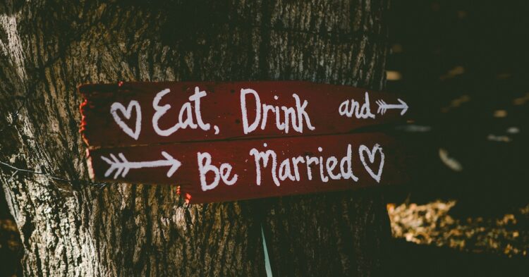 Eat Drink and Be Married sign on a tree