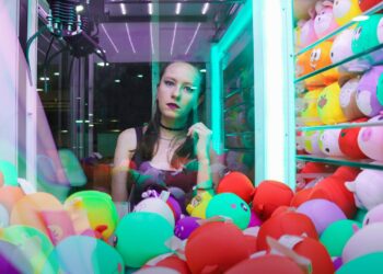 woman standing beside crane machine