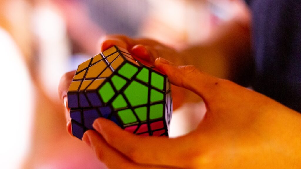 close up of someone playing with a 3 x 3 rubiks cube