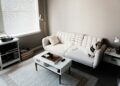white couch in front of white wooden table
