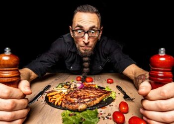 man looking mad at a dinner table