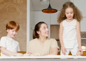 woman at a table with two kids