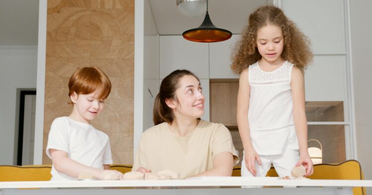woman at a table with two kids