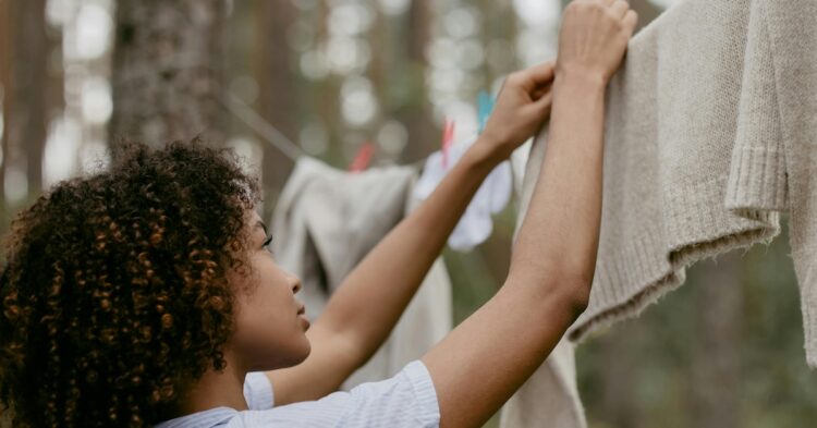 woman hanging clothes on a clothes line