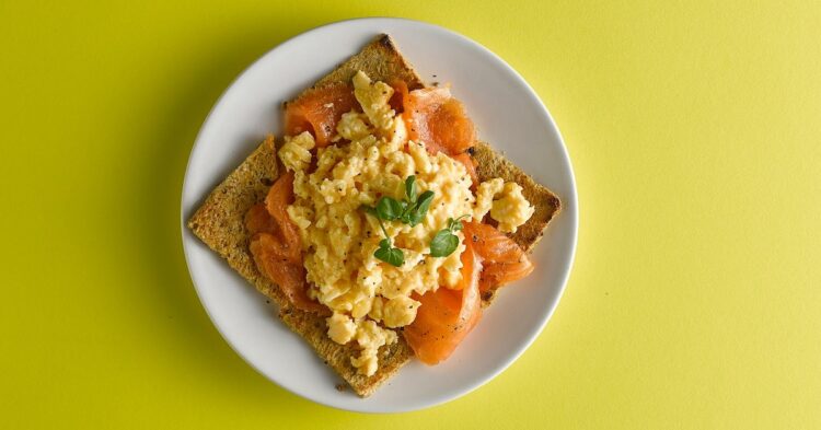 scrambled eggs with lox on a toast
